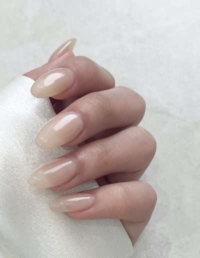Manicured nails with nude overlay.