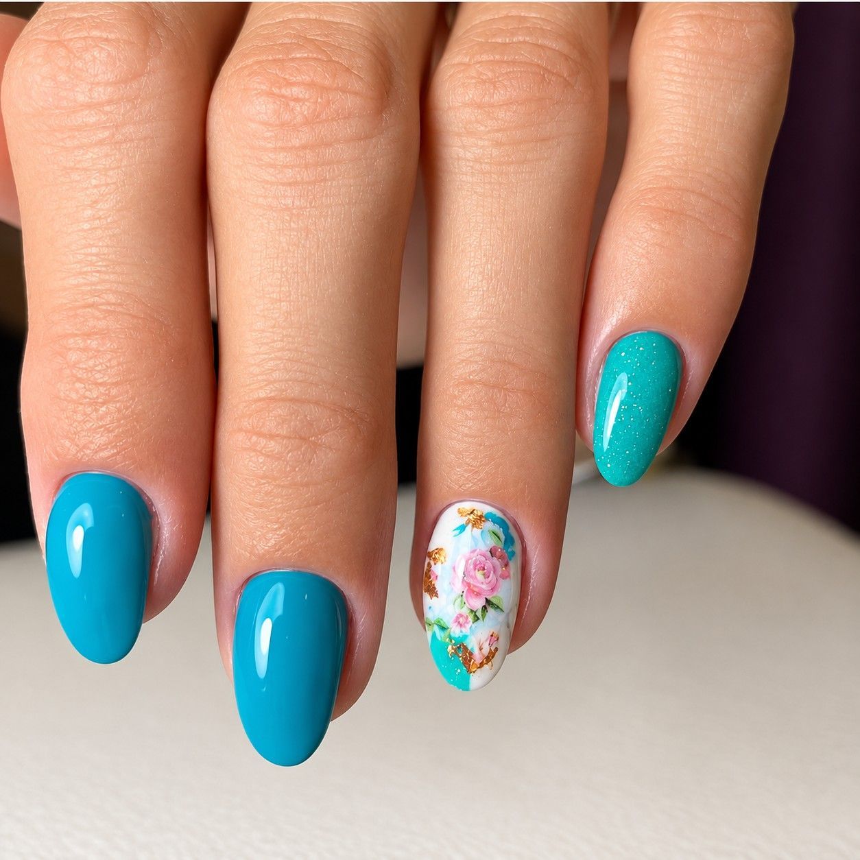 Turquoise manicure with a floral accent nail at Total Wrapture Medi Spa